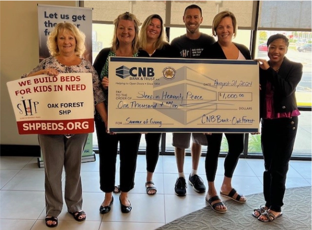 CNB presents check to Sleep in Heavenly Peace